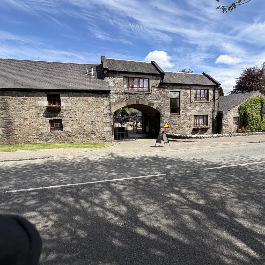The ivy-clad stone facade of Blair Athol Distillery in Pitlochry
