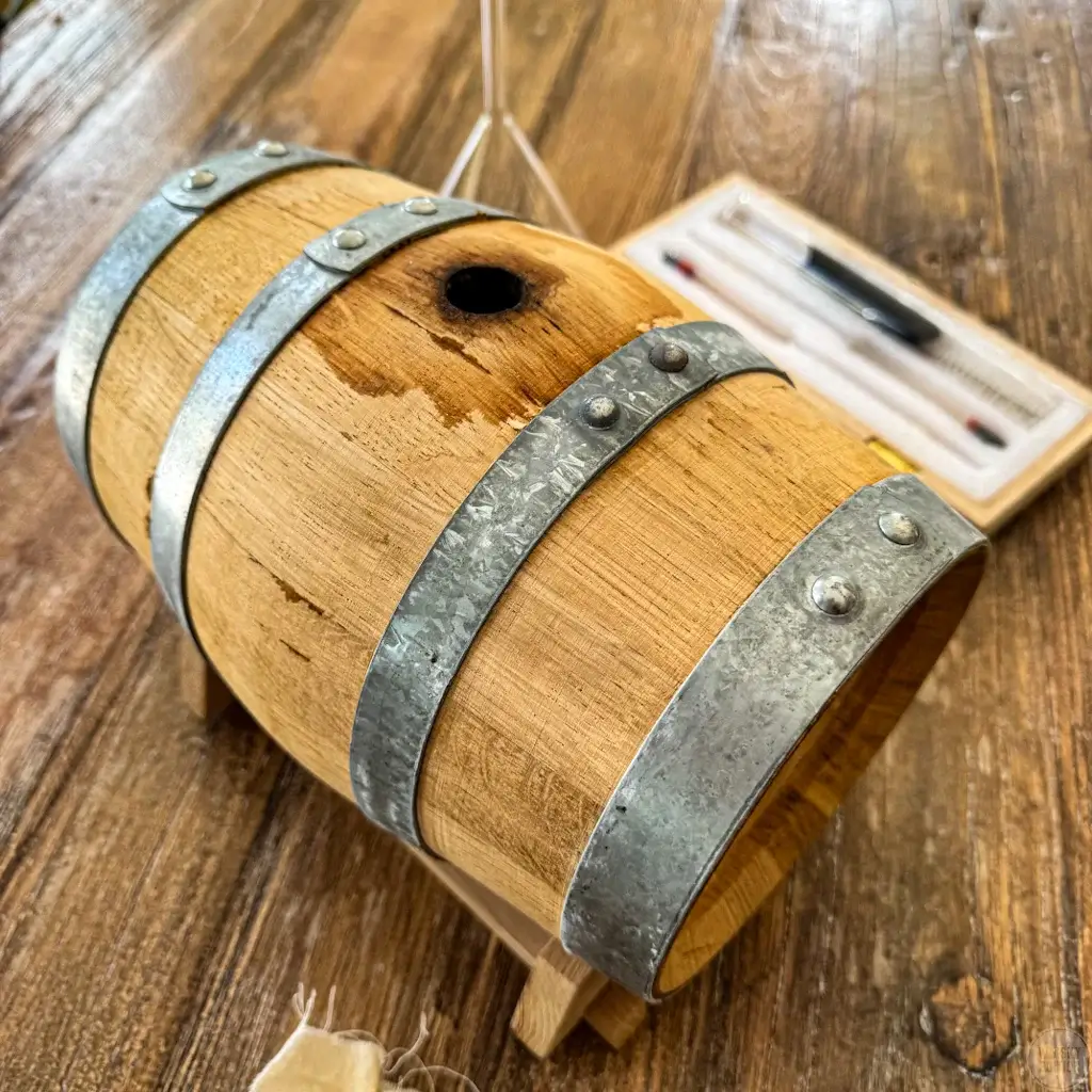 The 3-litre oak cask with metal hoops on a wooden stand