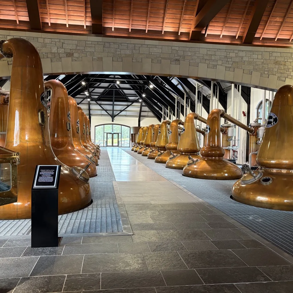 The Glenfiddich still house with two rows of copper pot stills beneath a timber roof