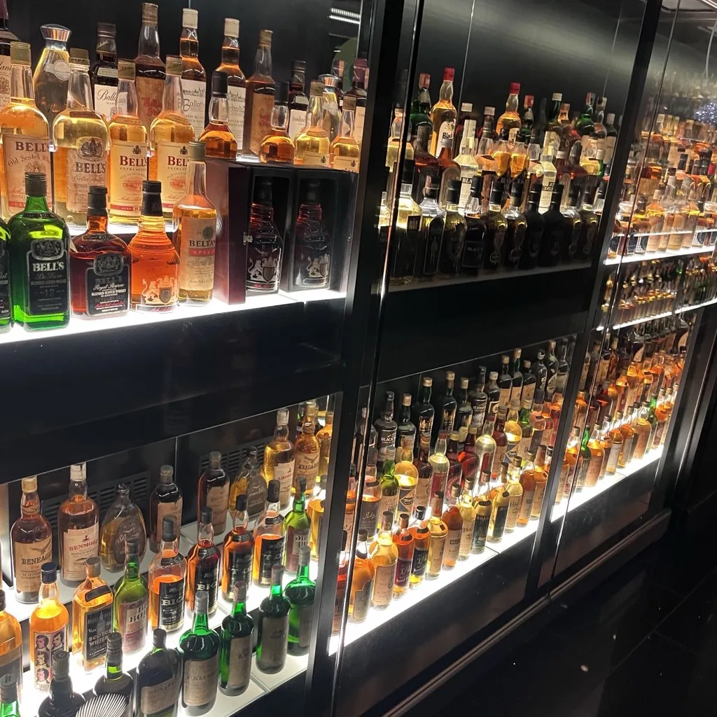 Illuminated glass cabinets full of whisky bottles at the Scotch Whisky Experience in Edinburgh